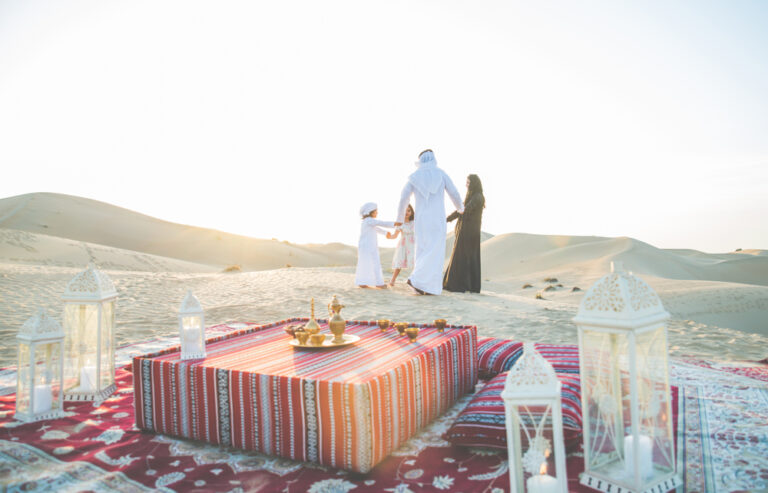 Family picnic in desert with Saudi food spread 2